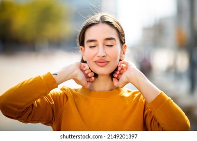 Close Up Portrait Of Pretty Young Caucasian Woman With Her Eyes Closed Standing Outside On A Summer Day