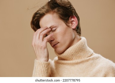 Close Portrait Of A Redhead Guy With Good Looks And Freckles On His Face With His Eyes Closed.