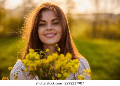 close portrait of a redhead woman smiling happily at the camera with a bouquet of yellow flowers - Powered by Shutterstock