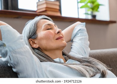 Close up portrait of a relaxing middle-aged woman having a break on the sofa - Powered by Shutterstock