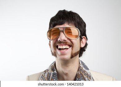 Close Up Portrait Of A Retro Man In A 1970s Leisure Suit And Sunglasses Smiling And Laughing