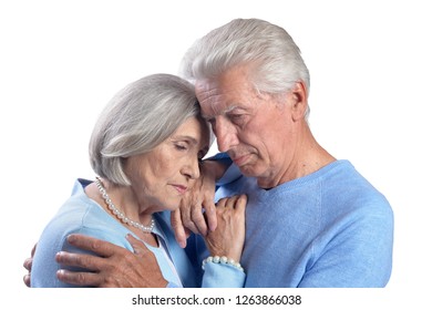 Close Up Portrait Of Sad Senior Couple Hugging