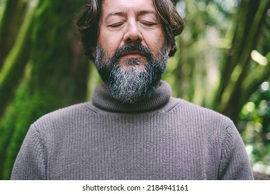 Close Up Portrait Of Senior Map With Closed Eyes In Inner Balance Serene Meditation Alone With Green Forest Nature In Background. Positive Lifestyle For Healthy People. Earth's Day Concept Lifestyle