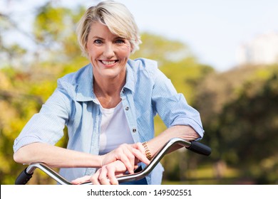 close up portrait of senior woman on a bicycle - Powered by Shutterstock