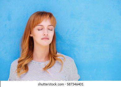 Close Up Portrait Of Serious Woman Standing With Eyes Closed In Contemplation