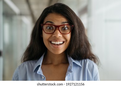 Close up portrait of smiling African American woman wearing stylish eyeglasses. Funny nerd student with open mouth looking at camera, education concept 