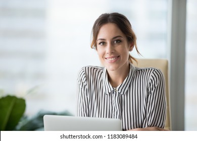 Close Up Portrait Of Smiling Beautiful Millennial Businesswoman Or CEO Looking At Camera, Happy Female Boss Posing Making Headshot Picture For Company Photoshoot, Confident Successful Woman At Work