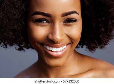 Close up portrait of smiling black female fashion model with curly hair