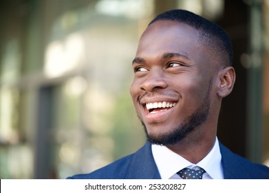 Close Up Portrait Of A Smiling Business Man In The City