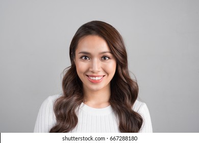 Close Up Portrait Of Smiling Confident Businesswoman Looking Straight, Isolated On Grey Background.