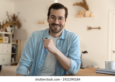 Close up portrait of smiling millennial Caucasian man talk speak on video call from home office. Happy young 20s male look at camera sit at desk have webcam digital meeting or virtual web conference.