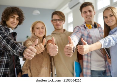 Close Up Portrait Of Smiling Multiracial Young People Show Thumbs Up Give Recommendation. Happy Diverse Multiethnic Students Recommend Good Quality Education Or Training Course.