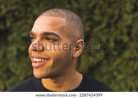 Close portrait of smiling young African American man with a buzz cut isolated. High quality photo