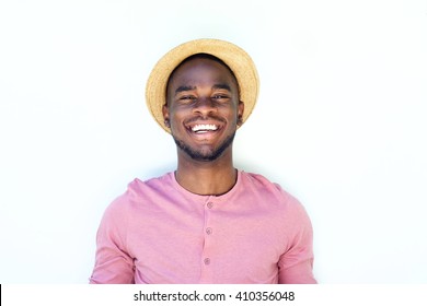 Close Up Portrait Of A Smiling Young Black Guy With Hat Against White Background