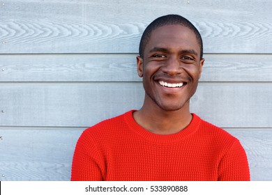 Close Up Portrait Of Smiling Young Black Guy In Red Sweater