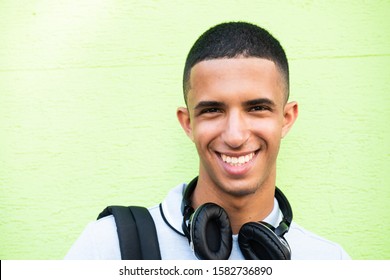 Close Up Portrait Of Smiling Young North African Man Against Green Background