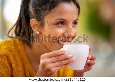 Close up portrait smiling young woman drinking cup of coffee