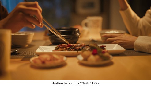 Close Up Portrait of a South Korean Young Couple Eating Food Together in the Kitchen. Cute Man and Woman are Happy with Their Lifestyle, Enjoying Traditional Korean Dinner with Meat and Rice - Powered by Shutterstock