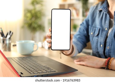 Close Up Portrait Of A Student Hand Showing Blank Smart Phone Screen On A Desk At Home