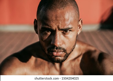 Close up portrait of sweaty african runner resting after workout outdoor - Powered by Shutterstock