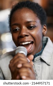 Close Up Portrait Of Talented Black Woman Singing To Microphone With Passion For Music And Art