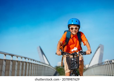 Close portrait of a teen boy on the bicycle cycle over bridge on bike lane with confident smile - Powered by Shutterstock