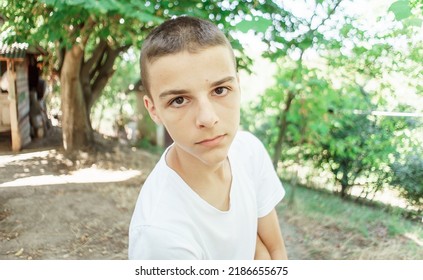 Close Up Portrait Of A Thin Boy Outside