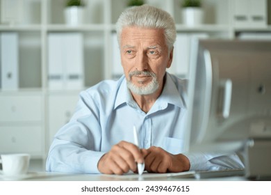 Close up portrait of thoughtful senior businessman working - Powered by Shutterstock