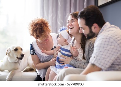 A Close Up Portrait Of Three Generations Of Women Being Close, Grandmother, Mother And Baby Daughter At Home