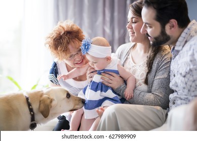 A Close Up Portrait Of Three Generations Of Women Being Close, Grandmother, Mother And Baby Daughter At Home