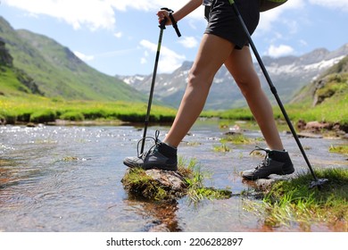 Close up portrait of a trekker legs crossing river walking with poles - Shutterstock ID 2206282897