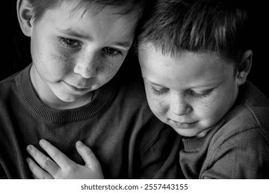 close portrait of two brothers with blue eyes, long dark eyelashes, and a face full of freckles - Powered by Shutterstock