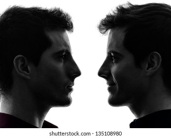 close up portrait  two caucasian young men in shadow  white background - Powered by Shutterstock