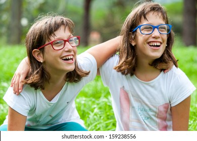 Close up portrait of two disabled twin sisters outdoors.