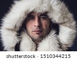 Close up portrait of a white man dressed with an eskimo jacket  looking at the camera