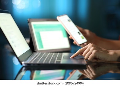 Close up portrait of a woman hand using multiple devices in the night at home