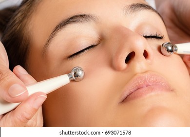 Close Up Portrait Of Woman Having Galvanic Facial Treatment With Low Level Current Electrodes.