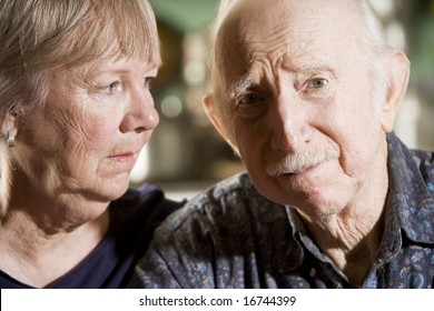 Close Up Portrait Of Worried Senior Couple