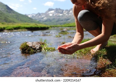 Close Up Portrait Of A Yogi Cupping Hands Catching Water From River In The Mountain