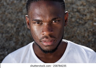 Close Up Portrait Of A Young African American Man With Sweat Dripping Down Face