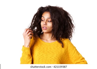 Close Up Portrait Of Young African Woman Holding Damaged Dry Hair And Looking Sad On White Background