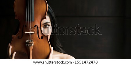 Close up portrait of young asian woman playing violin vintage style with copy space. Musician orchestra performer artist lifestyle concept panoramic banner