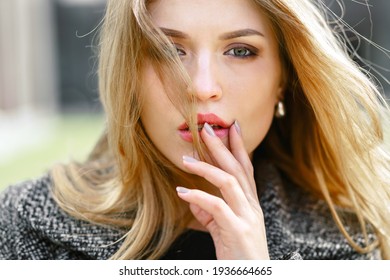 Close up Portrait, Young beautiful blonde woman posing outdoors in sunny weather.