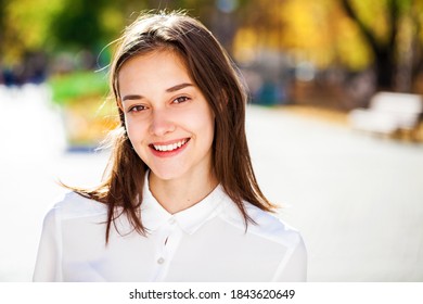 Close up portrait of a young beautiful girl in white shirt