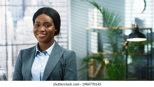 Close Up Portrait Of Young Beautiful Happy Female Worker Looking At Camera And Smiling In Cabinet. African American Woman Entrepreneur In Room At Workplace, Businesswoman, Professional Concept