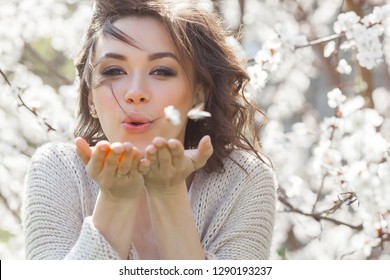 Close up portrait of young beautiful woman on spring background. Attractive young girl with flowers. Spring make up model.