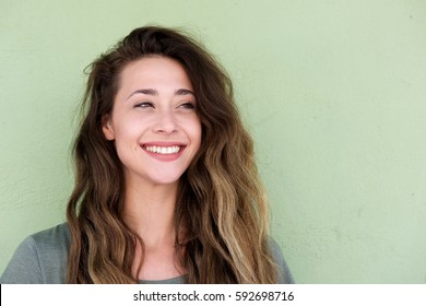 Close Up Portrait Of Young Beautiful Woman On Green Background Smiling