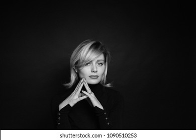 Close Up Portrait Of A Young Business Woman, Looking At The Camera, Against A Plain Studio Background