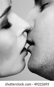 Close Up Portrait Of Young Caucasian Couple Kissing