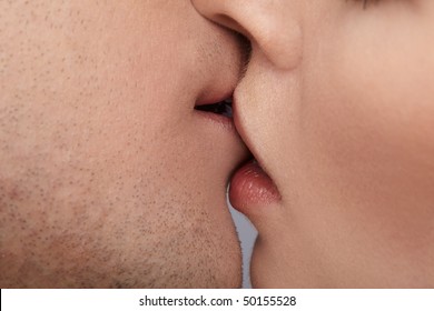 Close Up Portrait Of Young Caucasian Couple Kissing